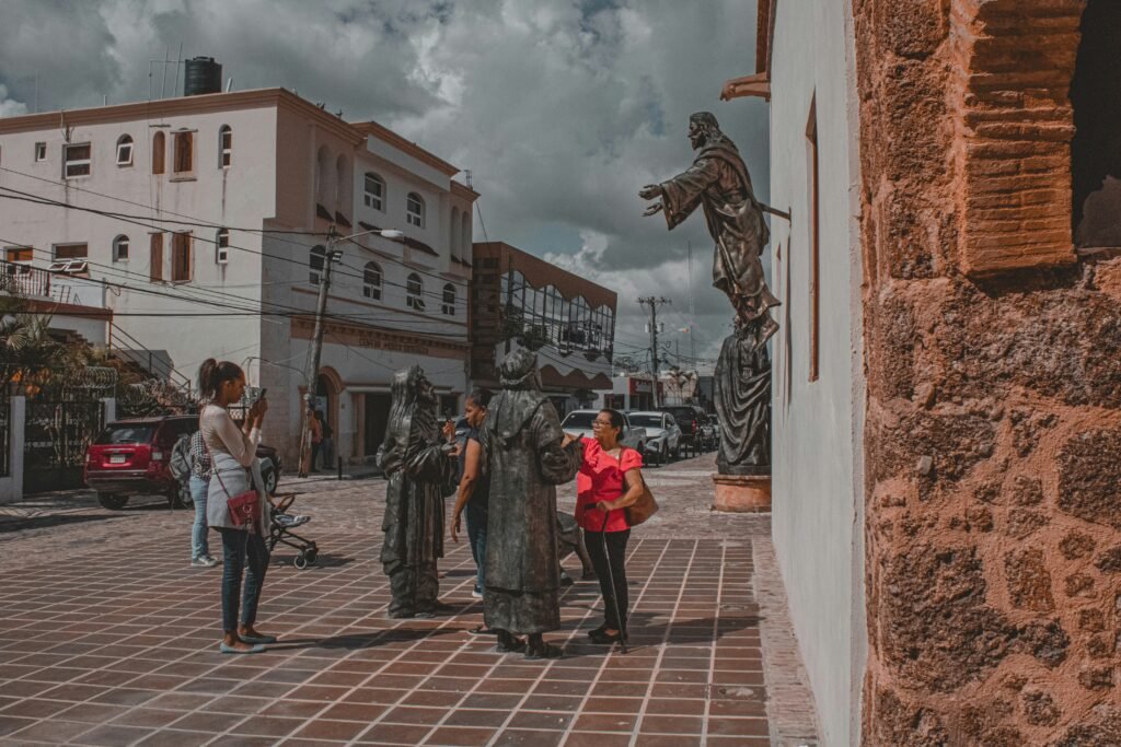 a group of people standing around a statue