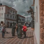 a group of people standing around a statue